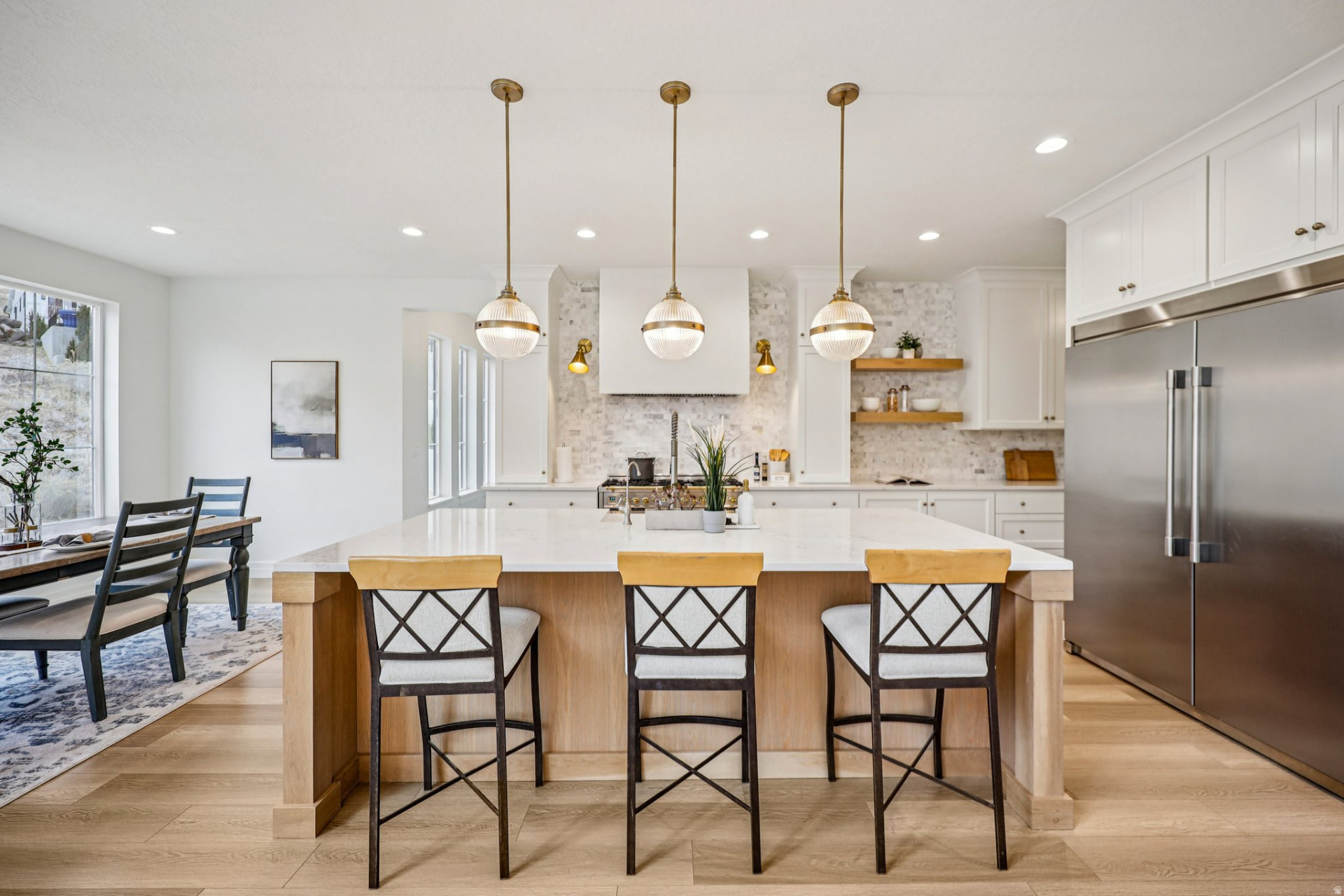 Bright kitchen with a large island and brass pendant lights in a new construction home in Lehi, Utah